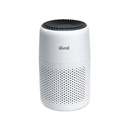 A white LEVOIT Core Mini Air Purifier with a cylindrical shape and a black air outlet at the top.